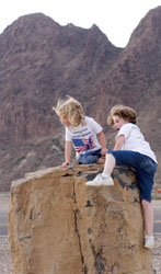 Kids climbing rocks.
